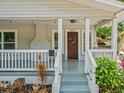 Inviting front porch with decorative wreath, string lights, and a cozy entryway at 4816 N Highland Ave, Tampa, FL 33603