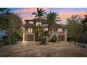 Charming home with stone driveway, lush landscaping, and two-story elevation at 5500 Leahy Ln, New Port Richey, FL 34652