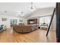 Bright and airy living room featuring vaulted ceiling, wood floors and large sectional at 5500 Leahy Ln, New Port Richey, FL 34652