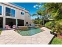 Inviting pool area with lush tropical landscaping, lounge chairs, and privacy fence at 5500 Leahy Ln, New Port Richey, FL 34652