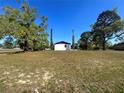 Spacious backyard with mature trees offering privacy and shade for the home at 6012 Landover Blvd, Spring Hill, FL 34609