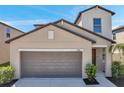 Charming home featuring a two-car garage and landscaped front yard at 6068 Apple Snail Ave, New Port Richey, FL 34653