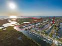 Breathtaking aerial view showcasing waterfront property with private dock, canal access, and stunning sunset backdrop at 6536 Beach Blvd, Hudson, FL 34667