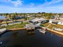 Waterfront home featuring a dock and boat lift for easy access to waterway at 6536 Beach Blvd, Hudson, FL 34667