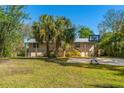 Spacious home exterior with metal roof, lush yard, and a basketball hoop for outdoor fun at 7240 Creek Dr, New Port Richey, FL 34655