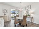 Cozy dining area featuring a stylish chandelier and access to the outdoor living space at 778 Parsons Mooring Ct, Seffner, FL 33584