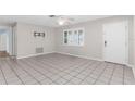 Spacious living room with neutral walls, tile flooring, ceiling fan and a large window at 8364 Eldridge Rd, Spring Hill, FL 34608