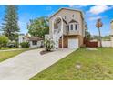 Beautiful home with two-car garage, inviting staircase, and a well-maintained lawn at 856 Wisconsin Ave, Palm Harbor, FL 34683