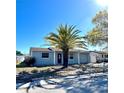 This single-story home features a palm tree in the front yard, attached garage, and a well-maintained lawn and inviting entrance at 9350 Barrington Ln, Port Richey, FL 34668