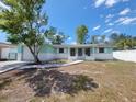 Charming single-story home featuring a well-maintained yard and a brick and siding facade at 10921 Stamford Dr, Port Richey, FL 34668