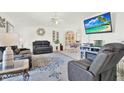 Bright and inviting living room with a comfortable sofa and tile flooring, great for relaxing at 11256 Holbrook St, Spring Hill, FL 34609