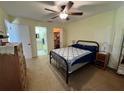 Bedroom with fan, furniture, walk in closet, and en suite bathroom at 11310 Carriage Hill Dr # 4, Port Richey, FL 34668