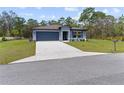 Charming single-story home with a well-manicured lawn and a two-car garage at 12201 Labrador Duck Labrador Duck Rd, Weeki Wachee, FL 34614