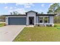 Beautiful one-story home with a two-car garage, pretty yard, and stylish shutters at 12201 Labrador Duck Labrador Duck Rd, Weeki Wachee, FL 34614