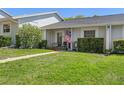Well-maintained home exterior with green lawn and welcoming front porch at 12505 Dearborn Dr # C, Hudson, FL 34667