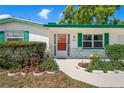 Up close view of the home's front door and nicely landscaped yard at 12613 Social Dr, Hudson, FL 34667