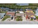Aerial view of a neighborhood street with well-maintained homes, driveways, and boat docks along the canal at 12801 5Th Isle, Hudson, FL 34667