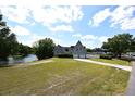 Charming home featuring a neatly manicured lawn, symmetrical roof lines, and attached two car garage at 23310 Cascade Pl, Land O Lakes, FL 34639