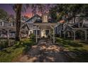 Charming townhomes with covered parking, highlighted by a beautiful sunset backdrop at 290 Winchester Way, Palm Harbor, FL 34684