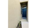 Stylish front door with transom window and neutral exterior paint at 3037 Jacob Crossing Ln, Holiday, FL 34691