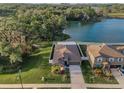 Stunning aerial view of home with lake and lush landscaping providing a serene and private setting at 36419 Flats St, Zephyrhills, FL 33541