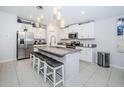 Bright kitchen boasts stainless steel appliances, granite countertops, and a large center island with seating at 36419 Flats St, Zephyrhills, FL 33541
