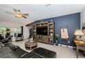 Comfortable living room with a large entertainment center and a cozy seating arrangement at 36419 Flats St, Zephyrhills, FL 33541