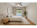 Serene bedroom with sliding doors to the pool area, natural light, wood floors, and neutral decor at 5412 Merkin Pl, New Port Richey, FL 34655