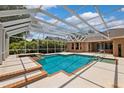 Sparkling screened-in pool and spa offering a relaxing outdoor retreat with ample lounging space at 7925 Calindra Ct, Trinity, FL 34655