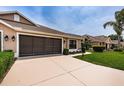 Attractive home featuring an attached two-car garage with brown trim and a well-manicured front lawn at 9636 Brookdale Dr, New Port Richey, FL 34655
