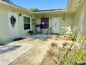 Inviting courtyard entrance with seating area, plants, and dual front doors at 12037 Boynton Ln, New Port Richey, FL 34654