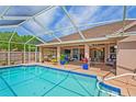 Inviting screened-in pool with ample patio space for outdoor entertaining at 12300 Drake Ln, Spring Hill, FL 34609