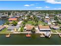 Aerial view of waterfront homes with docks and boatlifts along a canal at 13811 Michelle Ave, Hudson, FL 34667