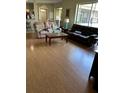 Spacious living room with wood floors and comfortable seating arrangements, perfect for relaxing and entertaining guests at 1704 Winn Arthur Dr, Valrico, FL 33594