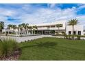 Expansive modern home featuring well-manicured lawn, a circular driveway, and a captivating water feature at 18725 Jiretz Rd, Odessa, FL 33556