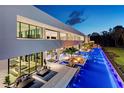 Beautiful backyard with a long pool, fire pit, an outdoor bar, and seating areas, perfect for entertaining at 18725 Jiretz Rd, Odessa, FL 33556