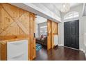 The foyer features stylish wood-look floors and decorative sliding barn doors leading to another room at 3017 Aldoro Ave, Spring Hill, FL 34609