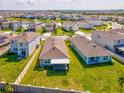 Aerial view of a well-maintained neighborhood, the property has a green lawn and partial fencing at 30839 Penny Surf Loop, Wesley Chapel, FL 33545