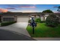 Inviting home with fresh landscaping, a two-car garage, and a serene twilight ambiance at 3160 Whispering Pines Ct, Spring Hill, FL 34606