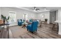 Bright living room with stylish furniture, wood-look floors, and a ceiling fan at 3416 Lema Dr, Spring Hill, FL 34609