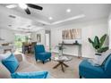 Cozy living room with tray ceiling, natural light, and a view into the dining area at 3416 Lema Dr, Spring Hill, FL 34609