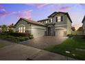 Gorgeous two-story home featuring a tile roof, three-car garage, and well-maintained landscaping at 4012 Dragonfly Trl, Odessa, FL 33556