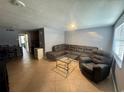 Large living room features tile floors, neutral walls, and a comfortable seating area, perfect for relaxation at 4235 Sheldon Pl # 4235, New Port Richey, FL 34652