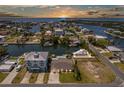 Sunset aerial view of waterfront community with private docks and ocean access at 4503 Jacona Dr, Hernando Beach, FL 34607