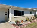 Single story home with neutral stucco exterior and well maintained yard, featuring tasteful potted plant accents at 4653 Cambridge Ave # 4653, New Port Richey, FL 34652