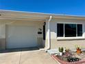 Single story home with attached garage, neutral stucco exterior, and well maintained yard, under clear blue skies at 4653 Cambridge Ave # 4653, New Port Richey, FL 34652