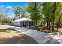 A beautifully landscaped property with a long driveway leading to a well-maintained single-story home at 5342 Leisure St, Dade City, FL 33523
