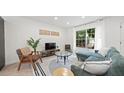 Stylish living room featuring a comfortable sofa, modern decor, a large window and neutral color palette at 5417 Carlton Rd, New Port Richey, FL 34652