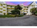 Exterior view of the condo building with balconies and lush landscaping, offering a glimpse of coastal living at 5537 Sea Forest Dr # 301, New Port Richey, FL 34652