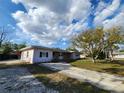 This lovely single-story home features a long driveway and spacious front yard at 6819 Treehaven Dr, Spring Hill, FL 34606